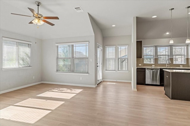 kitchen featuring ceiling fan, dishwasher, pendant lighting, a wealth of natural light, and light wood-type flooring