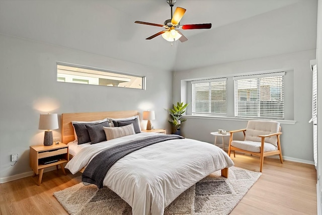 bedroom featuring ceiling fan, vaulted ceiling, and light hardwood / wood-style flooring