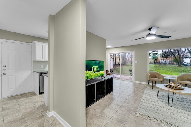 living room with ceiling fan and light tile patterned floors