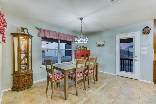 190 Margies Way, Bastrop, TX 78602 - dining area with a chandelier, baseboards, and light tile patterned flooring