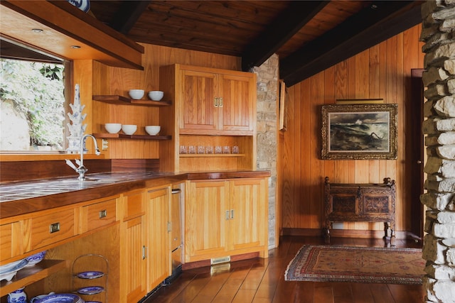 kitchen with dark wood-type flooring, wooden ceiling, beam ceiling, and wooden walls