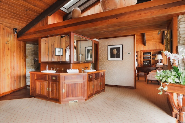 bar with lofted ceiling with beams, sink, wooden walls, and wooden ceiling