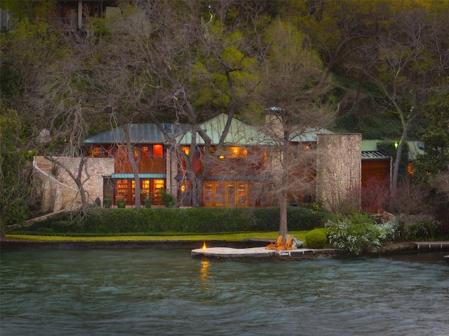 back of property with a water view