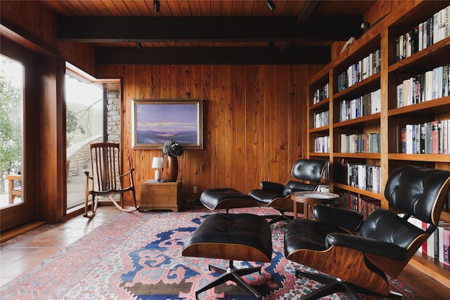 tiled office space with built in shelves, beamed ceiling, wooden walls, and wooden ceiling