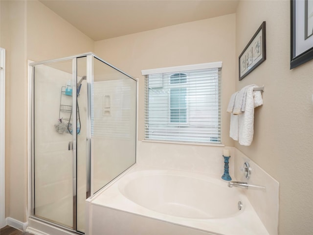 bathroom with separate shower and tub