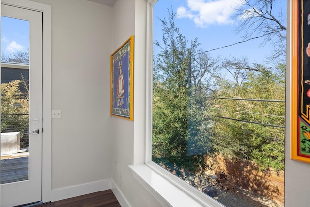 doorway to outside with dark wood-type flooring