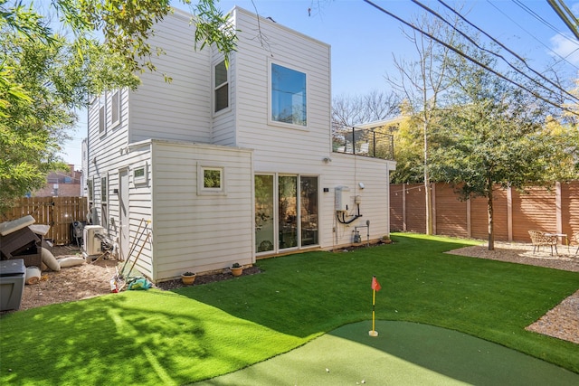 rear view of property with a yard