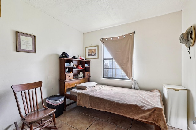 bedroom with tile patterned flooring and a textured ceiling