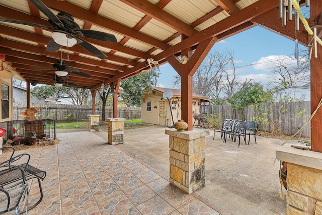 view of patio / terrace with ceiling fan and an outdoor structure