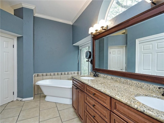 bathroom featuring tile patterned floors, vanity, a healthy amount of sunlight, ornamental molding, and a washtub