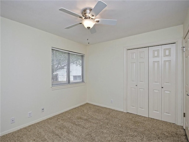 unfurnished bedroom with ceiling fan, carpet, and a closet