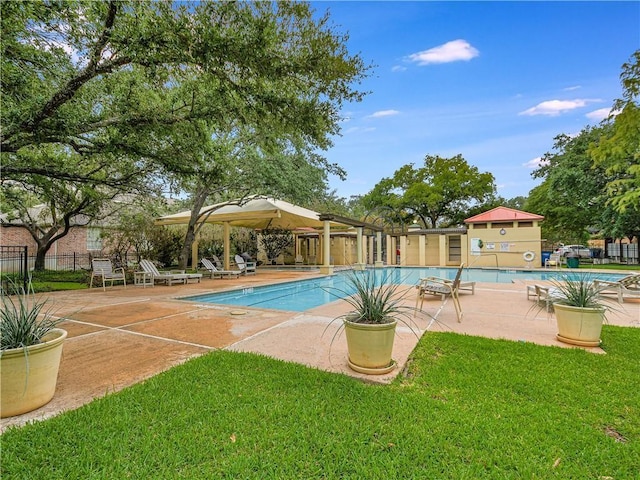 view of swimming pool with a patio area and a yard