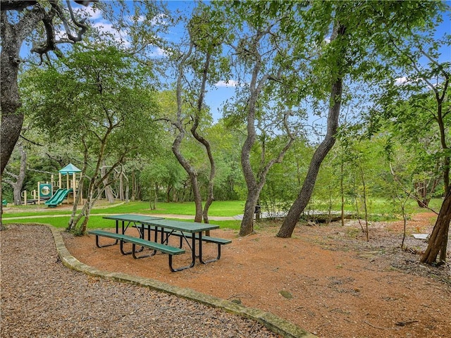 view of community with a lawn and a playground