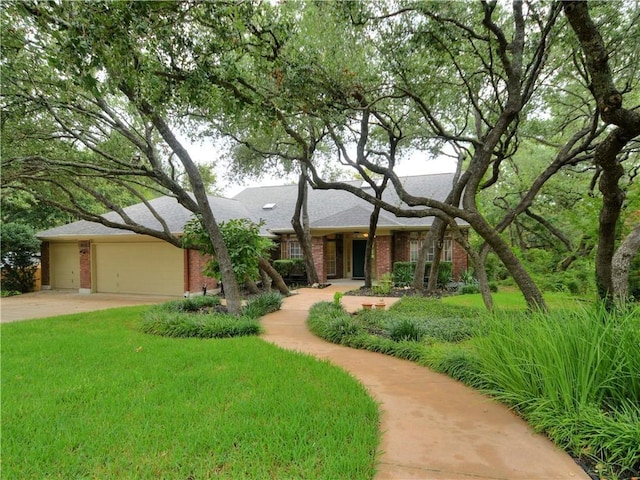 view of front of home with a garage and a front lawn