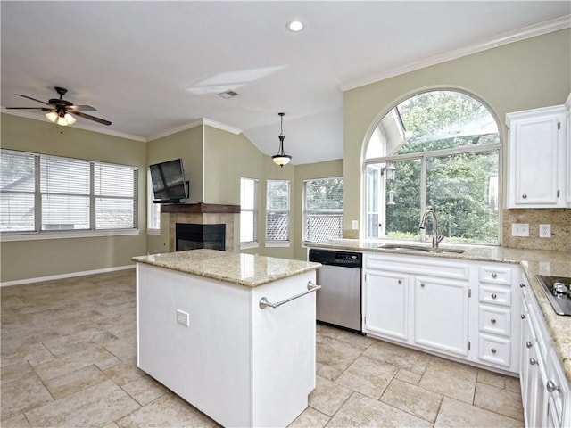 kitchen featuring stainless steel dishwasher, hanging light fixtures, sink, white cabinets, and a kitchen island