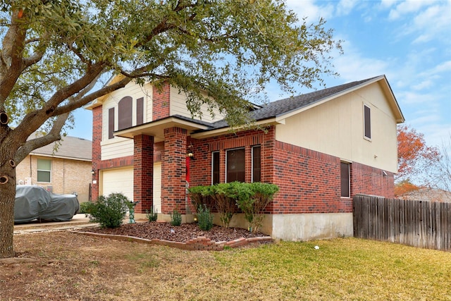 view of front of property featuring a front yard and a garage