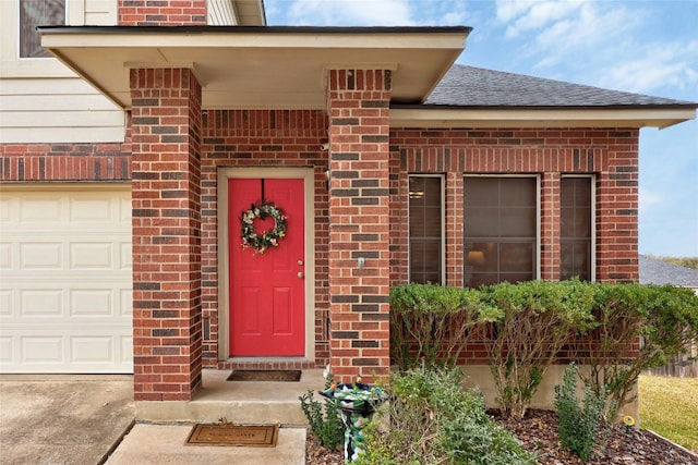 doorway to property with a garage