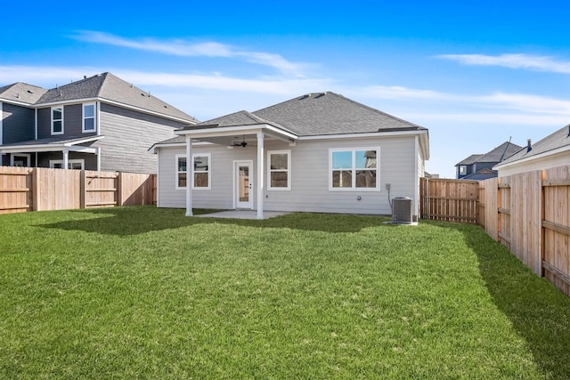 rear view of house with ceiling fan, a yard, a patio, and central AC