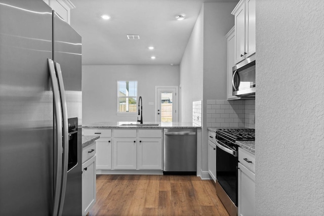 kitchen featuring white cabinets, appliances with stainless steel finishes, and sink