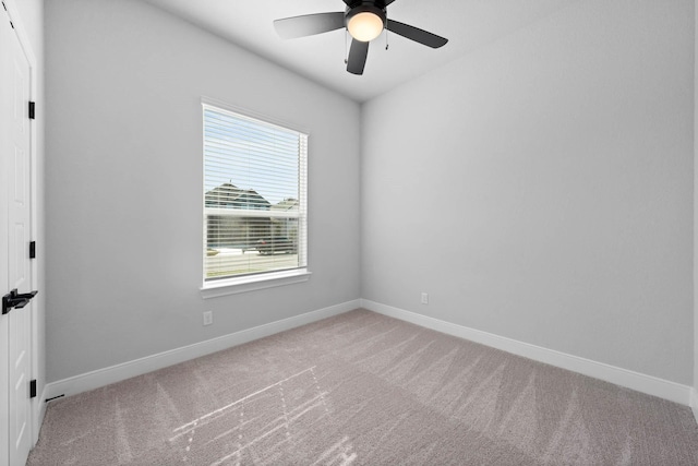 empty room featuring carpet, ceiling fan, and a wealth of natural light