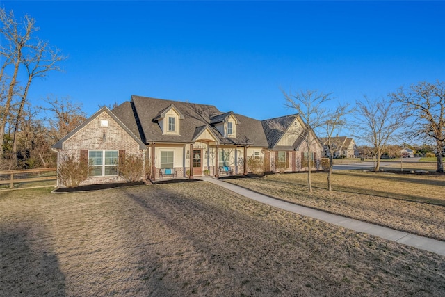 cape cod home with a front lawn