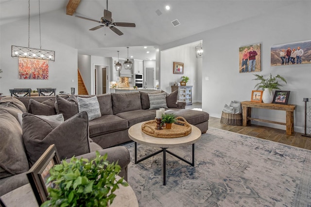 living room featuring ceiling fan, high vaulted ceiling, beam ceiling, and hardwood / wood-style floors