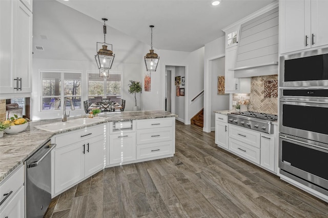 kitchen featuring dark hardwood / wood-style flooring, pendant lighting, stainless steel appliances, light stone countertops, and white cabinets