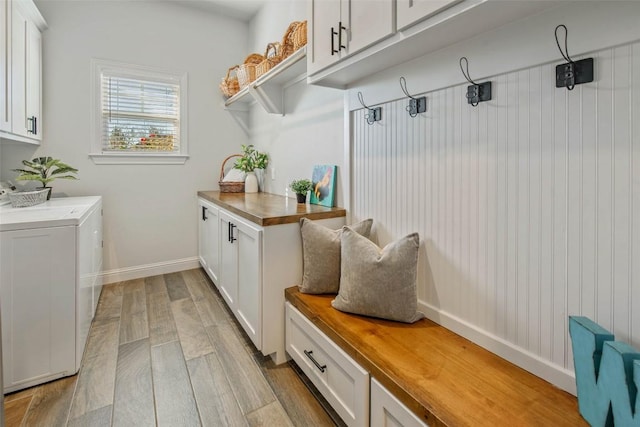 mudroom featuring washing machine and dryer and light wood-type flooring