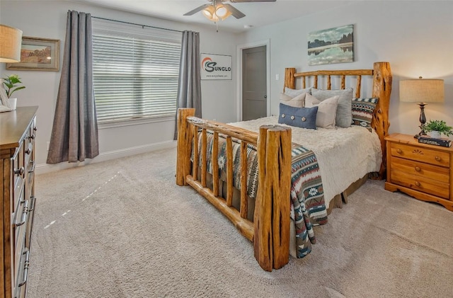 bedroom with ceiling fan and light carpet