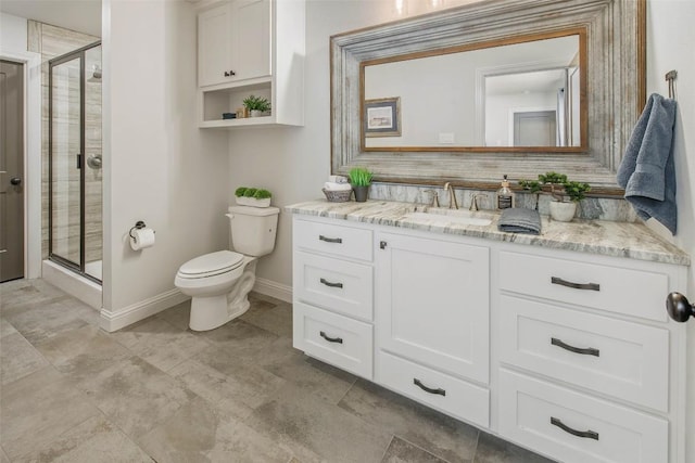 bathroom with vanity, toilet, and a shower with shower door