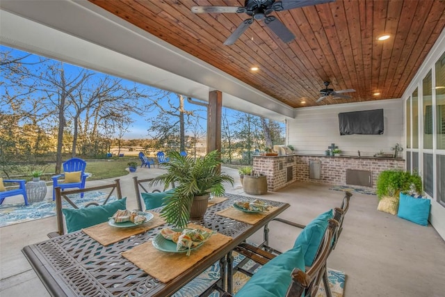 view of patio / terrace with an outdoor living space, ceiling fan, and an outdoor kitchen