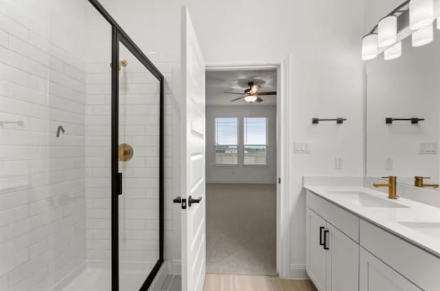 bathroom featuring a shower with shower door, vanity, and ceiling fan