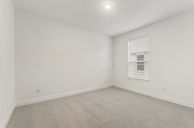 empty room featuring light colored carpet