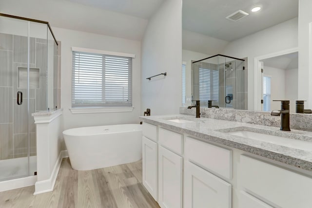 bathroom featuring hardwood / wood-style floors, vanity, lofted ceiling, and shower with separate bathtub