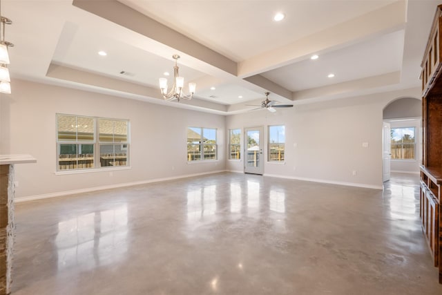 unfurnished living room featuring concrete floors, a raised ceiling, beamed ceiling, and ceiling fan with notable chandelier