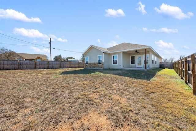 back of property with ceiling fan, a patio area, and a lawn