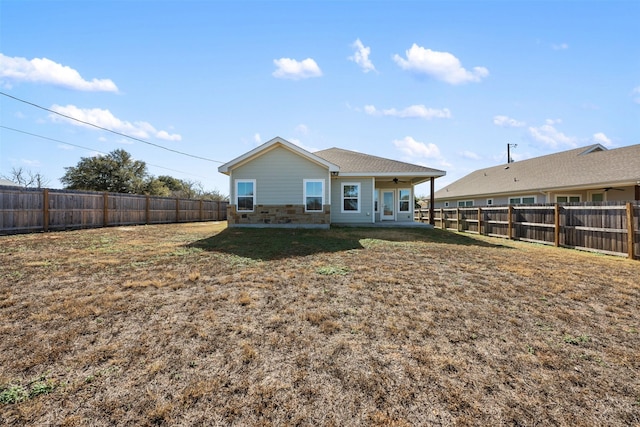 rear view of house with a patio area and a yard