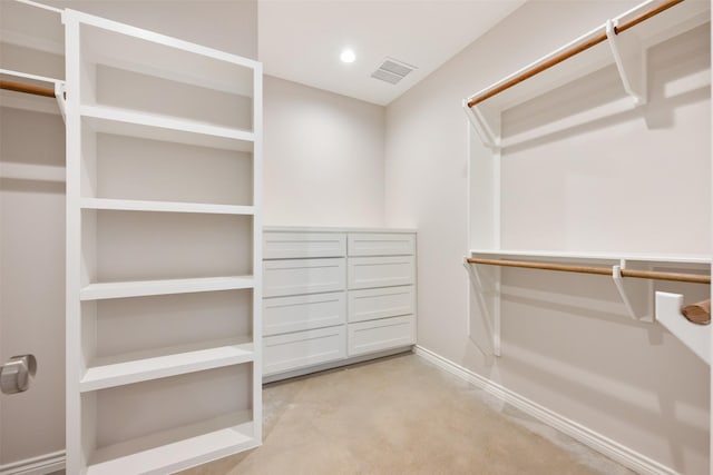 walk in closet featuring light colored carpet