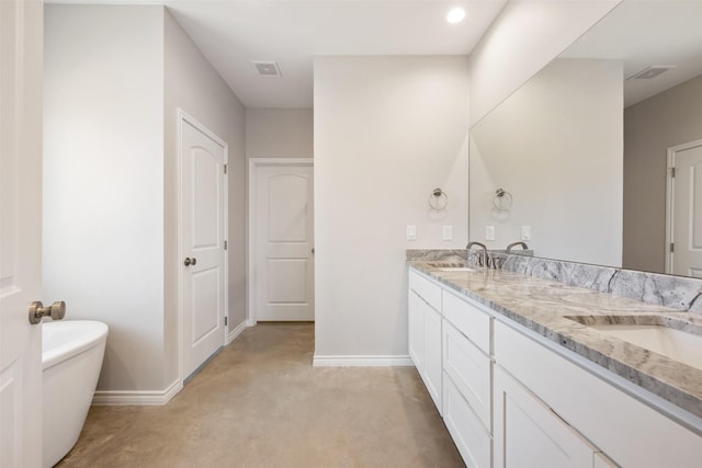 bathroom featuring vanity and a bath