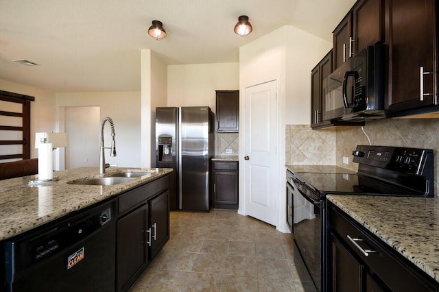 kitchen with black appliances, decorative backsplash, sink, dark brown cabinets, and light stone counters