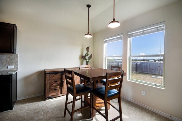 dining room featuring lofted ceiling