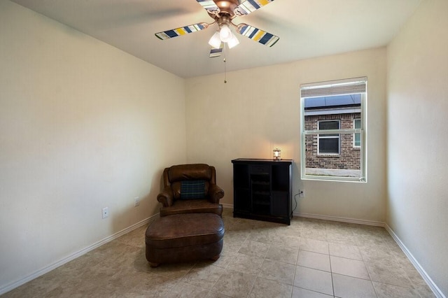 sitting room with ceiling fan and light tile patterned floors