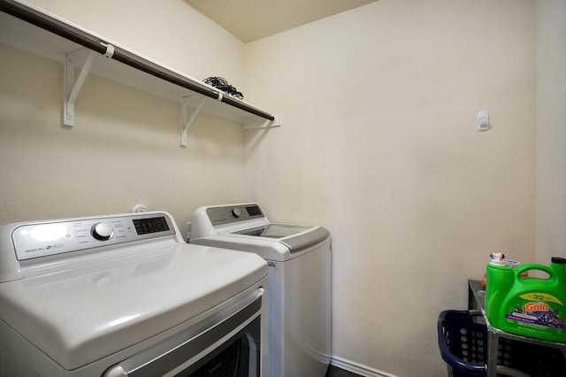 clothes washing area with independent washer and dryer