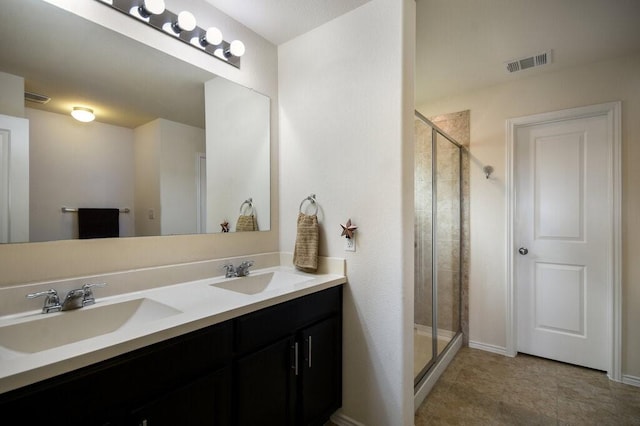 bathroom with vanity and a shower with door