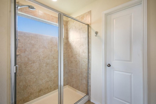 bathroom featuring a shower with shower door