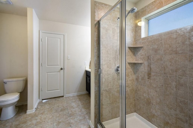 bathroom with toilet, vanity, and an enclosed shower