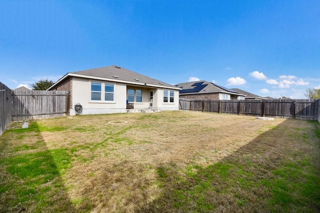 rear view of house with a yard