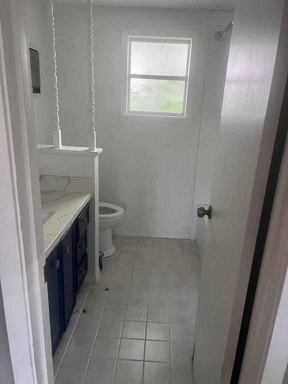 bathroom with tile patterned floors, toilet, and vanity