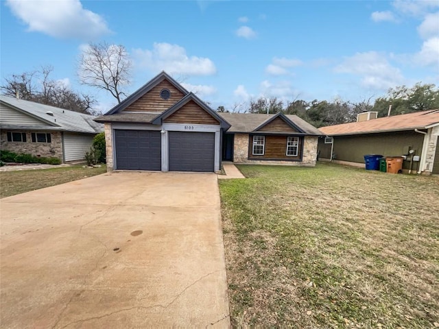 5103 Ganymede Dr, Austin, TX 78727 - view of front of home with an attached garage, driveway, a front yard, and stone siding