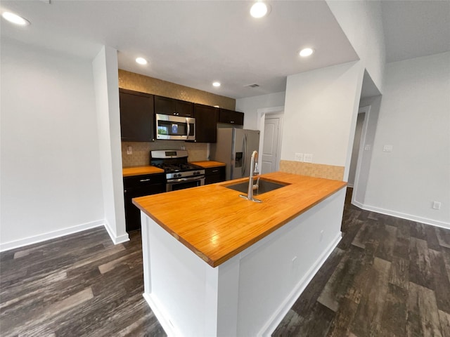 kitchen with decorative backsplash, sink, kitchen peninsula, dark hardwood / wood-style flooring, and stainless steel appliances